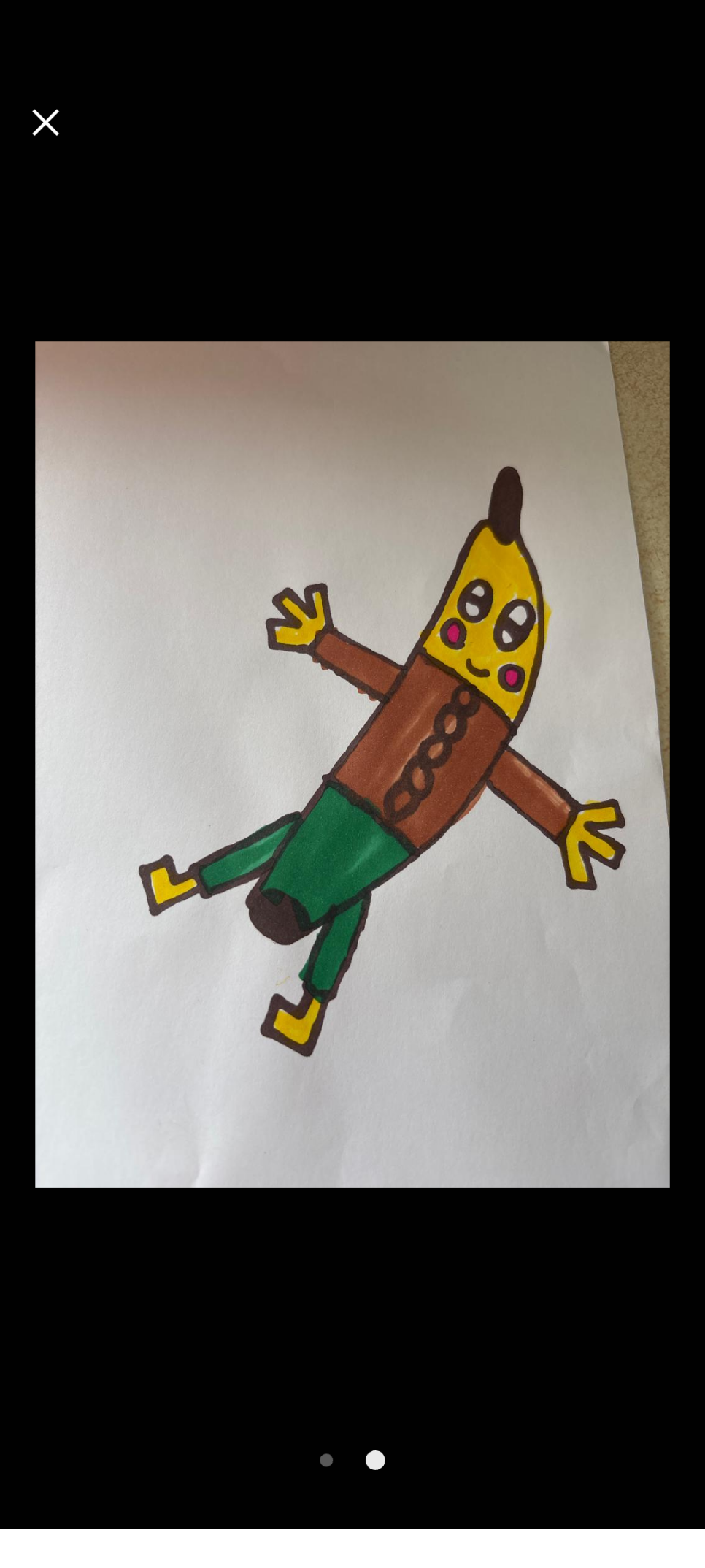 A child's drawing of a banana man, who is wearing  a brown long-sleeved top with five buttons and green trousers. He has a yellow banana head with a black stalk at the top and big white eyes with black horizontal pupils, two pink circles on his cheeks, and a little smile. He has yellow hands and feet and each hand has three fingers on it.